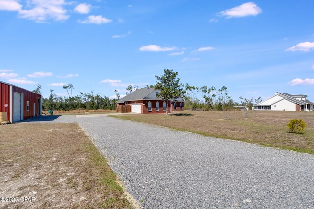 view of street featuring gravel driveway