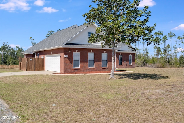 view of front of house featuring driveway, an attached garage, a front yard, and brick siding