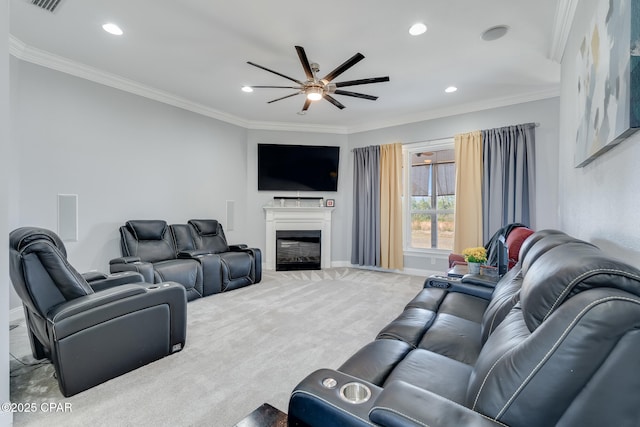 living area with ornamental molding, carpet flooring, a glass covered fireplace, and recessed lighting