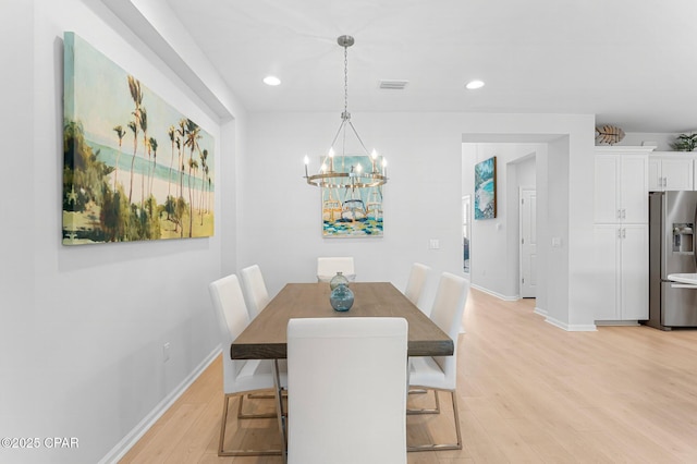 dining room featuring light wood-style floors, recessed lighting, baseboards, and an inviting chandelier