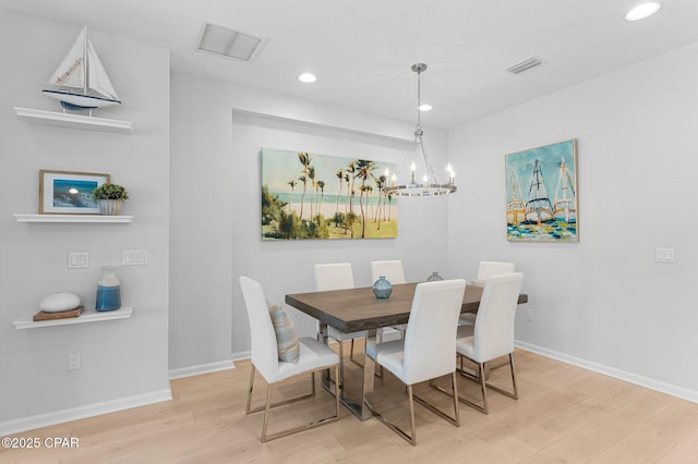 dining area with visible vents, baseboards, and wood finished floors