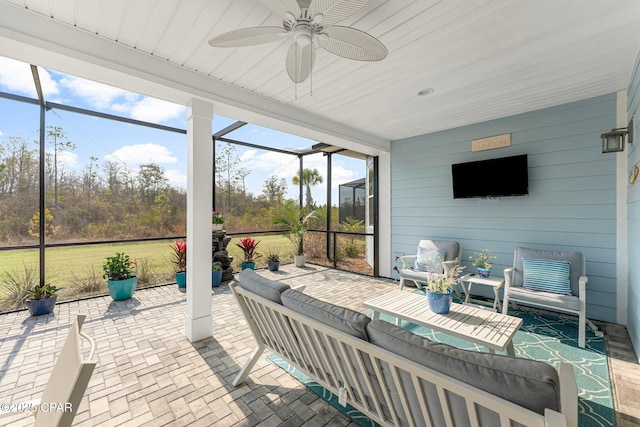 sunroom / solarium featuring a ceiling fan and wooden ceiling