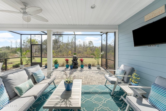 sunroom with ceiling fan and wood ceiling