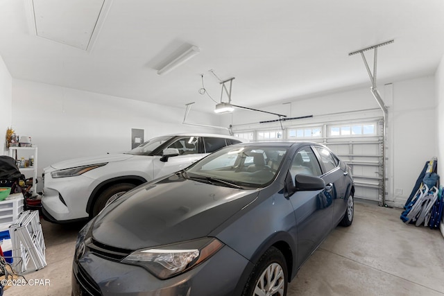 garage featuring electric panel and a garage door opener