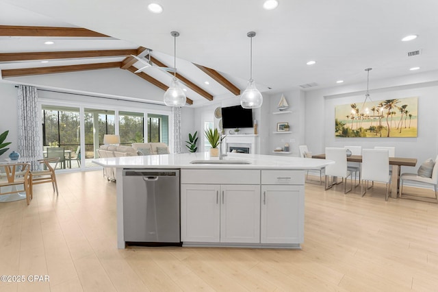 kitchen with lofted ceiling with beams, light wood-style flooring, stainless steel dishwasher, open floor plan, and a sink