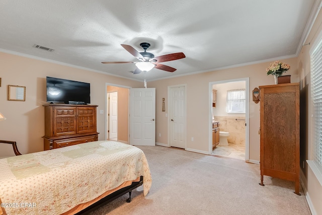 bedroom featuring light carpet, ornamental molding, ensuite bath, and visible vents