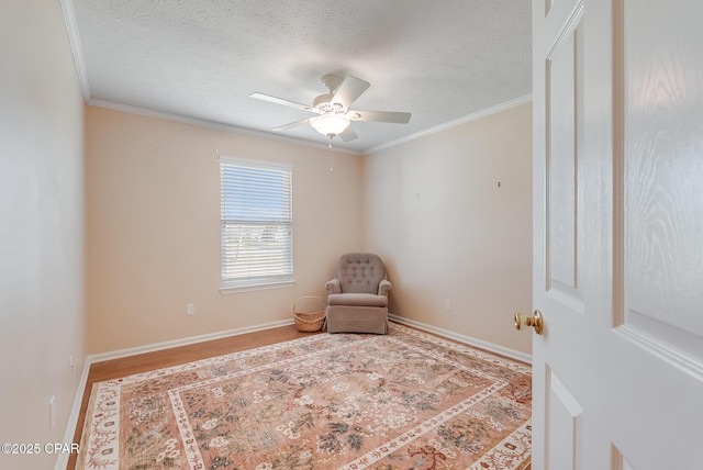 unfurnished room with baseboards, ornamental molding, and a textured ceiling