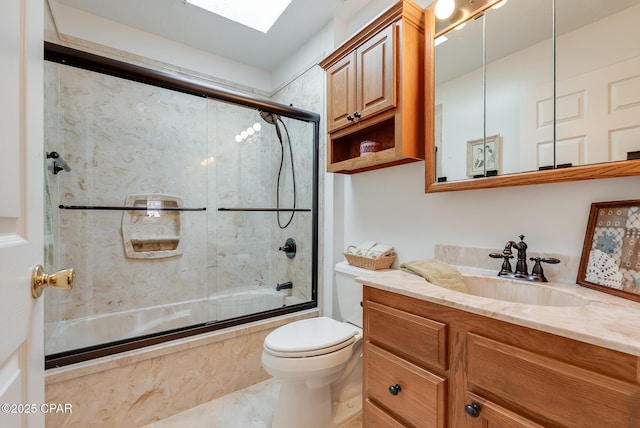 full bath with a skylight, combined bath / shower with glass door, vanity, and toilet