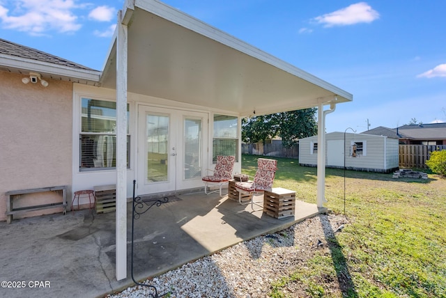 view of patio featuring an outbuilding, french doors, and fence