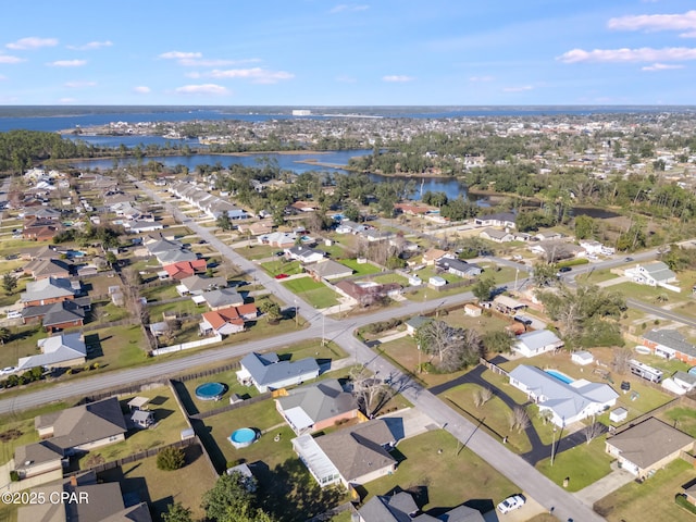 bird's eye view featuring a water view and a residential view