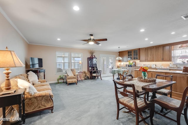 dining space with recessed lighting, ornamental molding, light colored carpet, and french doors