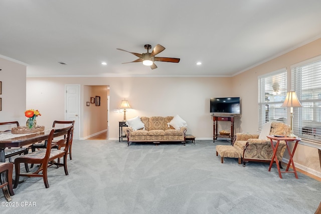 living room with light colored carpet, visible vents, ornamental molding, ceiling fan, and baseboards