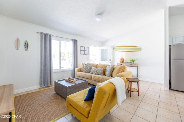 5801 Pinetree Avenue A, B, C & D, Panama City, FL 32408 - living room featuring lofted ceiling, baseboards, light tile patterned flooring, and a textured ceiling