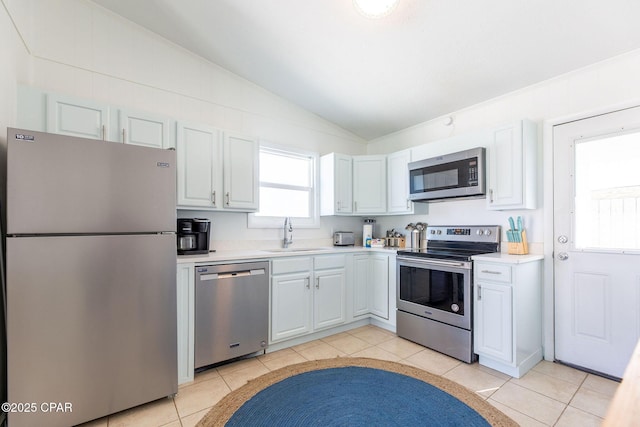 5801 Pinetree Avenue A, B, C & D, Panama City, FL 32408 - kitchen with appliances with stainless steel finishes, a sink, vaulted ceiling, light countertops, and light tile patterned flooring