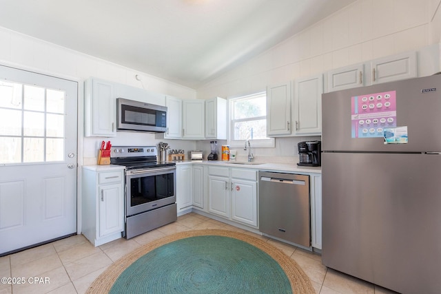 5801 Pinetree Avenue A, B, C & D, Panama City, FL 32408 - kitchen featuring appliances with stainless steel finishes, lofted ceiling, a sink, light countertops, and light tile patterned flooring