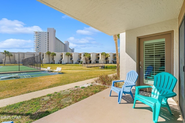 view of patio / terrace featuring shuffleboard and fence