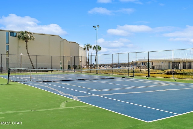 view of tennis court with fence