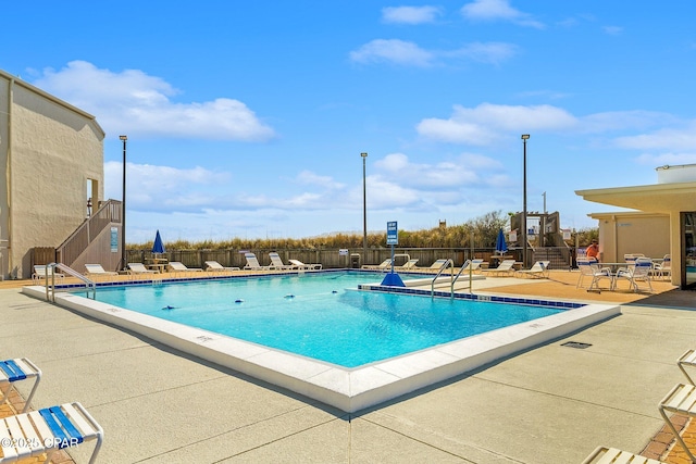 pool featuring a patio area and fence