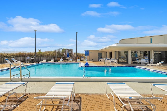 pool featuring a patio and fence