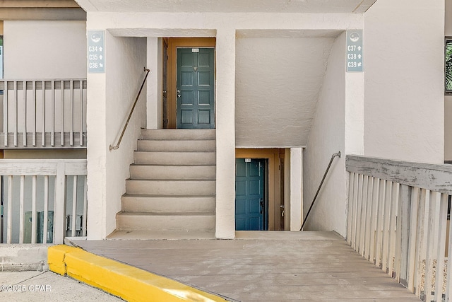 entrance to property with stucco siding