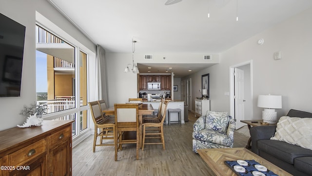 dining room with visible vents and light wood-style flooring