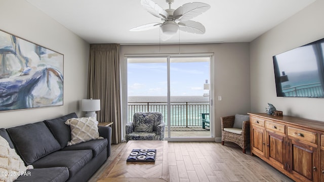 living room featuring light wood-style floors and a ceiling fan