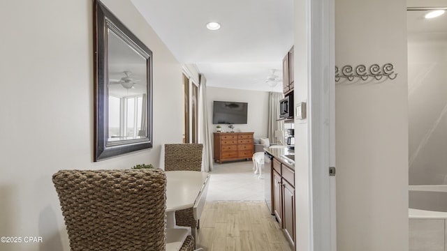 corridor with light wood-style floors and recessed lighting
