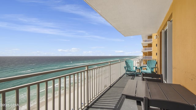 balcony with a beach view and a water view