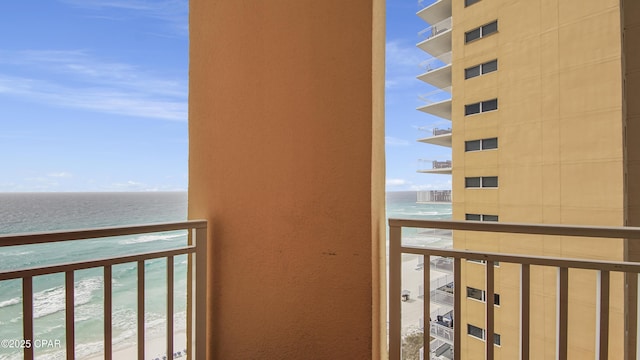 balcony featuring a water view and a view of the beach