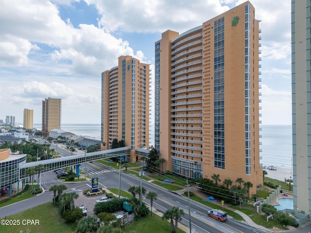 view of building exterior with a water view and a view of city