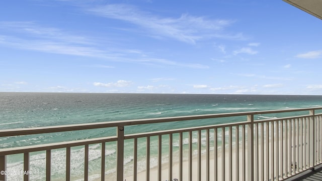balcony featuring a water view and a view of the beach