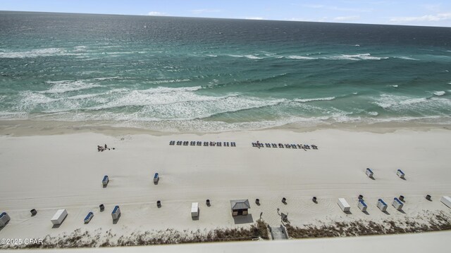 drone / aerial view featuring a water view and a beach view