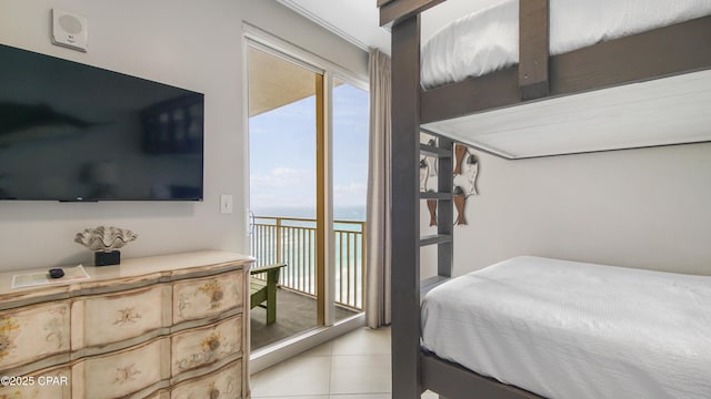 bedroom with light tile patterned floors and access to outside