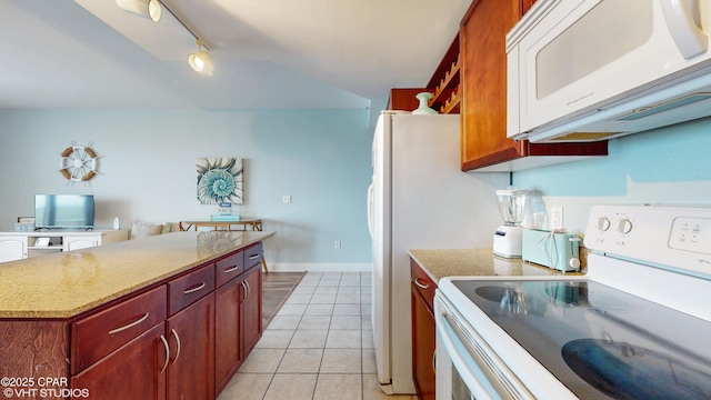 kitchen featuring a center island, light tile patterned floors, rail lighting, white appliances, and baseboards