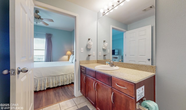 ensuite bathroom with visible vents, ensuite bathroom, ceiling fan, vanity, and tile patterned floors