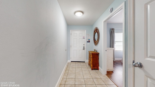 entryway featuring baseboards and light tile patterned floors