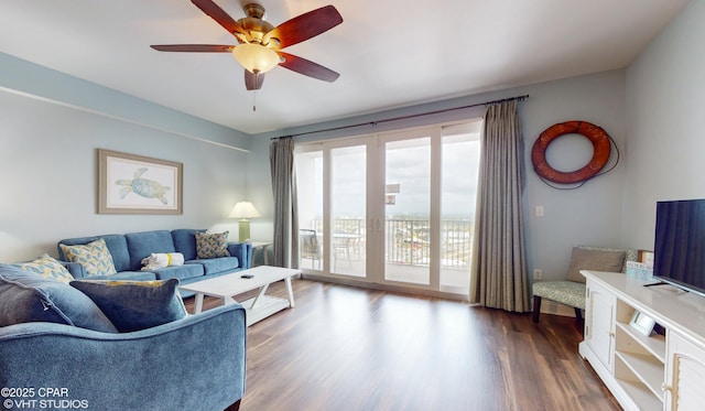 living room featuring dark wood-style flooring and ceiling fan