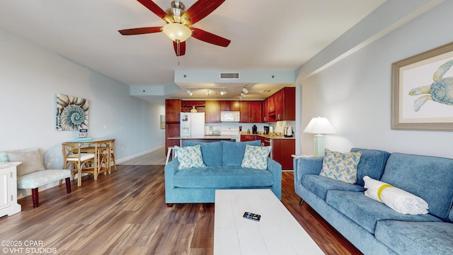 living room featuring baseboards, visible vents, dark wood finished floors, ceiling fan, and track lighting