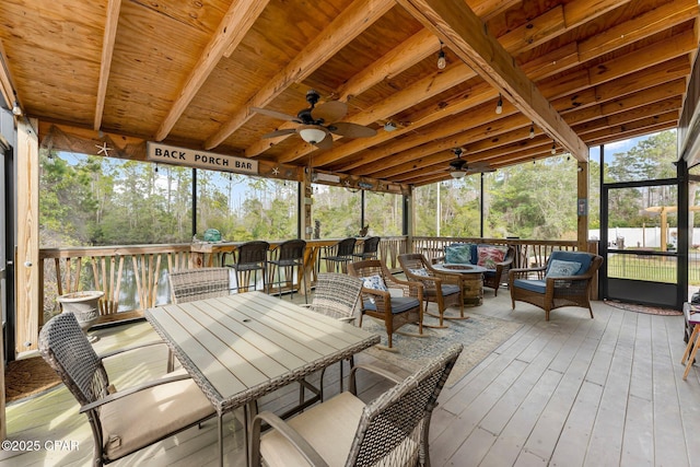 sunroom with wood ceiling and a ceiling fan