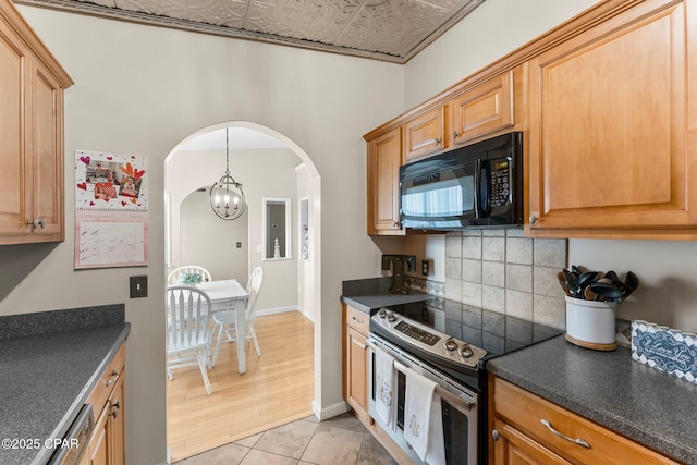 kitchen with dark countertops, stainless steel electric range oven, black microwave, and tasteful backsplash