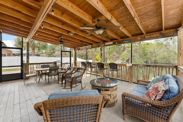 sunroom / solarium with wood ceiling and a ceiling fan