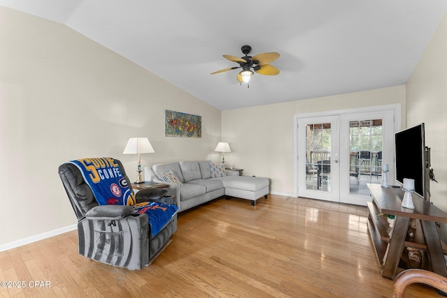 living area with lofted ceiling, a ceiling fan, wood finished floors, and french doors