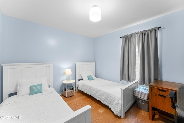 bedroom with light wood finished floors