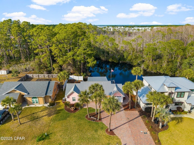 aerial view with a water view and a view of trees