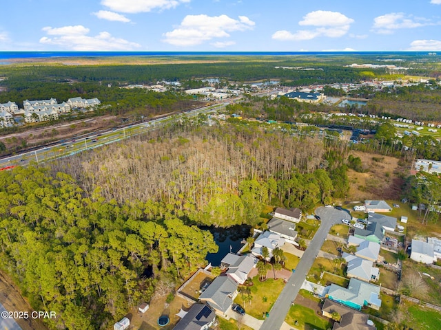 drone / aerial view with a residential view and a forest view