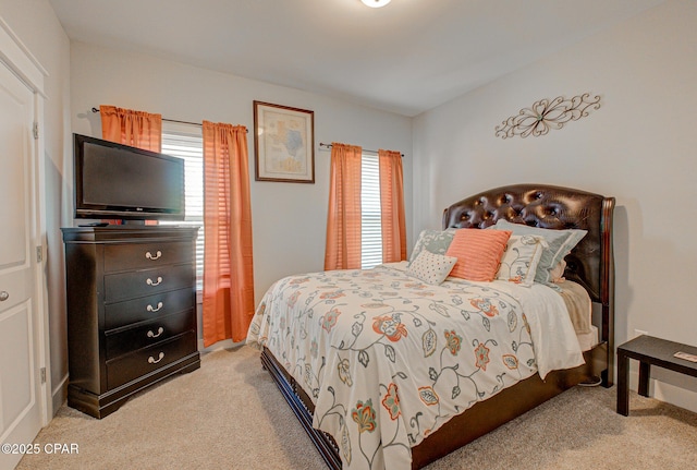 bedroom featuring light carpet