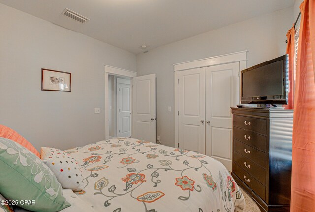 bedroom with a closet and visible vents