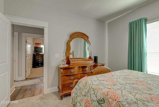 carpeted bedroom with baseboards