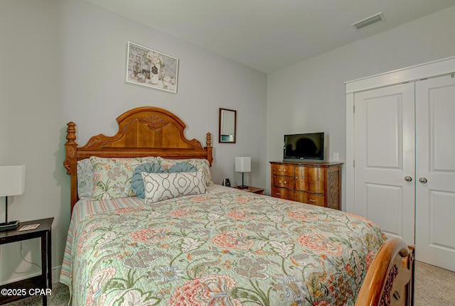 bedroom featuring carpet floors, visible vents, and a closet