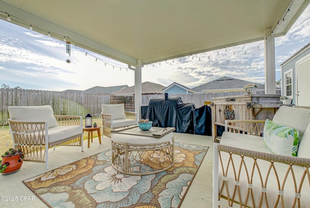 view of patio featuring outdoor lounge area, a fenced backyard, and grilling area